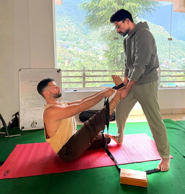 Ashok giving an alignment correction to a student